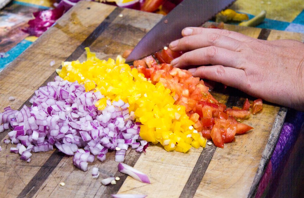 Chopped onions and peppers on cutting board