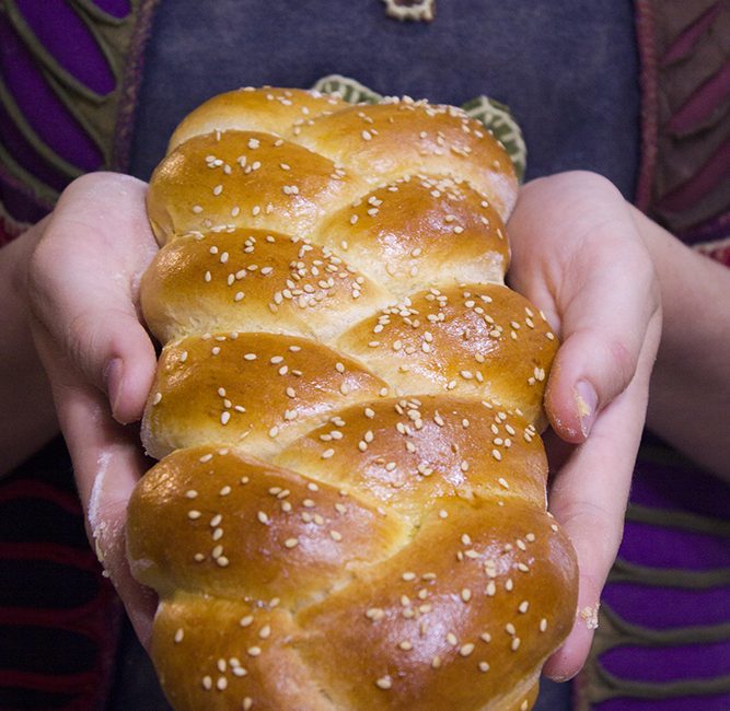 challah bread braid in hands