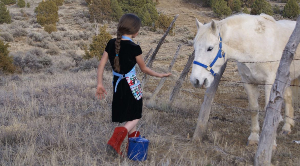 girl in red boots with white horse