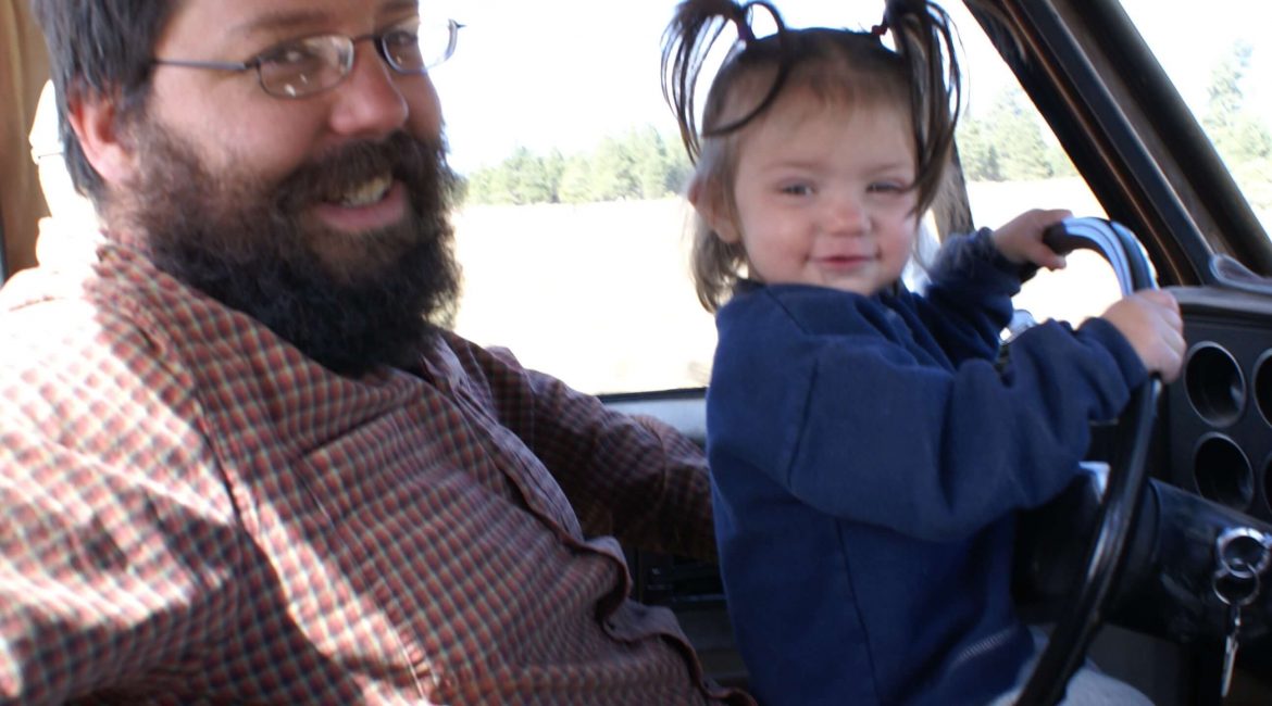 Daddy and little girl driving truck